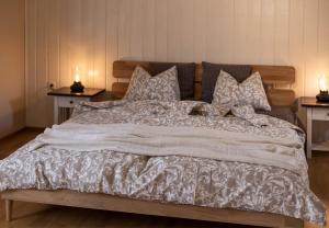 a large bed with a white comforter and pillows at Apartment ILWA in Schladming