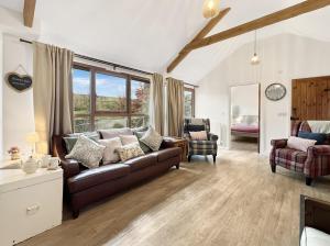a living room with a couch and a chair at Westlands Brendon Hill in Treborough
