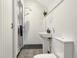 a white bathroom with a toilet and a sink at Westlands Brendon Hill in Treborough +11 photos