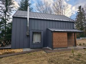 a small house with a solar roof on a yard at Спас Резорт in Spas