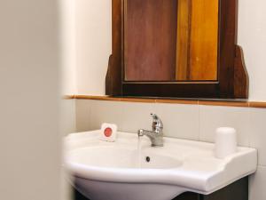 a bathroom sink with a mirror and a roll of toilet paper at Salina Castel Vinci in Rinella