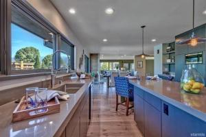 a kitchen with a large counter and a dining room at 2030 Marconi Way home in South Lake Tahoe +35 photos