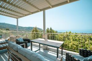 a patio with a table and chairs on a balcony at Elia Villas in Riglia