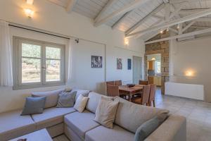 a living room with a couch and a table at Elia Villas in Riglia