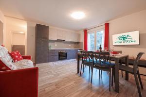 a kitchen and dining room with a table and chairs at Casa Adamello in Corteno Golgi