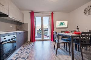 a kitchen and dining room with a table and chairs at Casa Adamello in Corteno Golgi