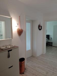 a white room with a mirror and a hallway at Ferienwohnung Jesper in Braunlage