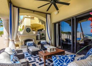 a living room with a patio with a fireplace at Villa Pura Vida in San José del Cabo +21 photos