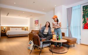 two women standing in a hotel room at Lub d Bangkok Chinatown - Steps from Sam Yod MRT Station in Bangkok