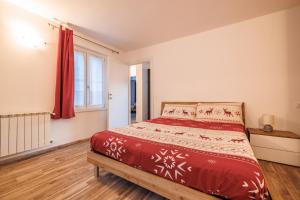 a bedroom with a bed and a window at Casa Adamello in Corteno Golgi +20 photos