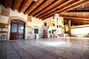 a large room with a wooden door in a building at Ca' Maiolo - Villa con piscina in Montecchio Maggiore