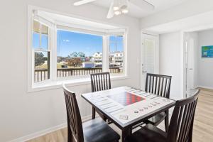 a dining room with a table and chairs and a window at CAC-23A - Yellowfin in Buxton
