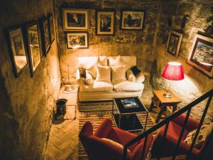 a living room with a couch and a table at Hotel El Convent 1613 in La Fresneda