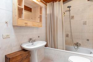 a bathroom with a sink and a toilet and a shower at Mansarda di charm Valli di Borzago in Mortaso +15 photos