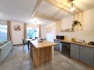 a kitchen and living room with a couch and a table at Le Plaisance de Mérignac in BOD