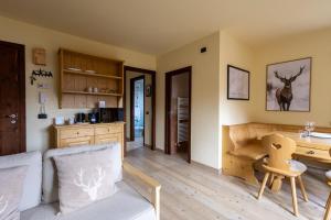 a living room with a couch and a table with a desk at Oga View Apartment in Oga