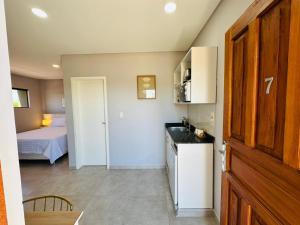 a room with a kitchen and a bedroom with a bed at Alojamiento Del Lago in Cambyretá +7 photos