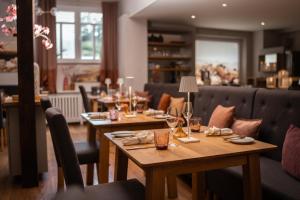 a restaurant with two tables and chairs with glasses at Landgasthaus & Hotel zur Krone in Dahn +41 photos