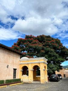 a building with a tree in front of it at Antigua Encantó Colonial in Antigua Guatemala