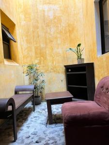 a living room with a couch and a table at Antigua Encantó Colonial in Antigua Guatemala