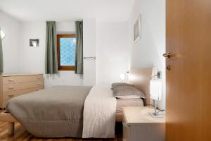 Ένα ή περισσότερα κρεβάτια σε δωμάτιο στο Jack Apartment In Pinzolo Center