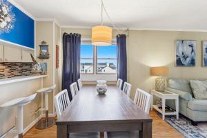 a dining room with a table and a couch at AV2-3E - Don't Blink in Croatan Shores