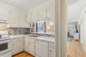 a kitchen with white cabinets and a sink at AV2-3E - Don't Blink in Croatan Shores +31 photos