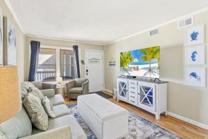 a living room with a couch and a tv at AV2-3E - Don't Blink in Croatan Shores