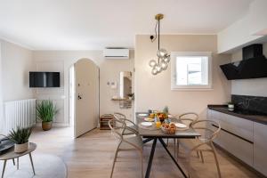 Una cocina y una sala de estar con mesa y sillas. en NEW Casa Florentia, en Ambrogiana