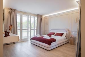 a bedroom with a large white bed with red pillows at NEW Casa Florentia in Ambrogiana