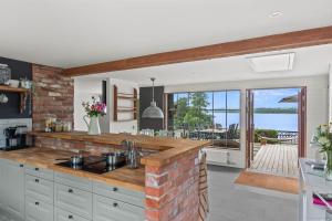 a kitchen with a brick wall and a counter top at Sjöutsikt Sövde in Sövde