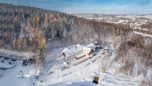 an aerial view of a house in the snow at Hotel Le Mont Medical & SPA in Świeradów-Zdrój