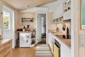 a kitchen with white cabinets and a white refrigerator at 3004-Stege-Paelen-21 in Stege