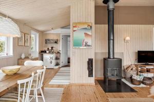 a kitchen and living room with a wood stove at 3004-Stege-Paelen-21 in Stege