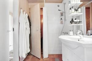 a white bathroom with a sink and a mirror at 3004-Stege-Paelen-21 in Stege +12 photos