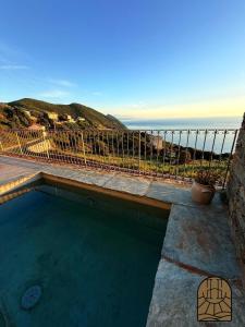 a swimming pool with a view of the ocean at Cap Helios l ecrin corse a couper le souffle in Morsiglia