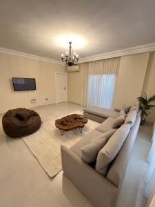 a living room with a couch and a table at Sela 1 in Cairo