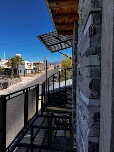 a stairway to a building with a stone wall at La unión in Ciudad Lujan de Cuyo