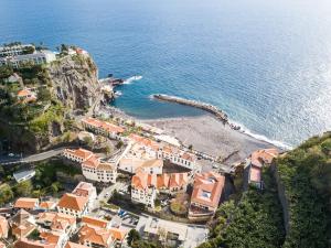 an aerial view of a town on a cliff next to the ocean at Sunny Escape - Ponta do Sol -- Vila Silva Upstairs in Ponta do Sol