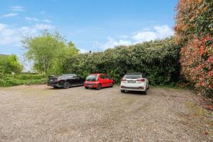 three cars parked in a gravel parking lot at For Workers Bedburg Hau in Bedburg Hau