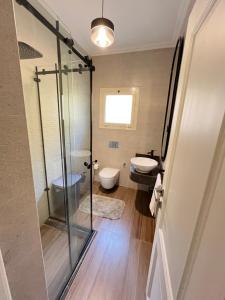 a bathroom with a glass shower and a toilet at Sela 1 in Cairo +7 photos