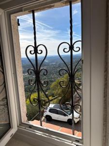 a car parked outside a window with a view at Bella Vista Cabris in Cabris +7 photos