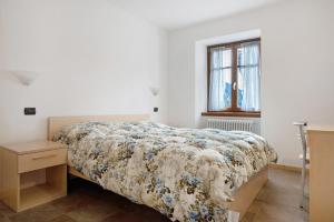 Ένα ή περισσότερα κρεβάτια σε δωμάτιο στο Casa Brenta - Alpine Charm