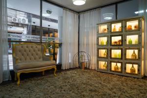 a room with a chair and a display case at Hotel Facon Grande in Buenos Aires