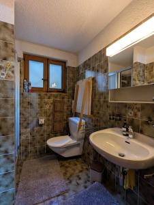 a bathroom with a toilet and a sink at Appartement-chalet à Verbier près des pistes in Verbier +11 photos