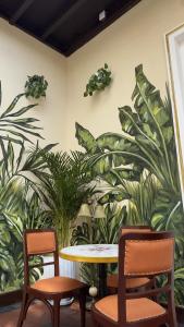 a table and two chairs in a room with plants at Ancestral Lima Downtown in Lima