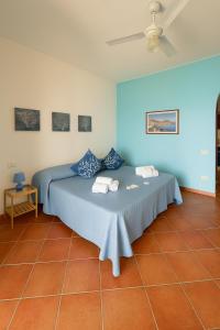 a bedroom with a bed with two pillows on it at Salina Castel Vinci in Rinella