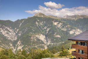 a view of a mountain range from a house at SWISSPEAK Resorts by Pierre & Vacances Premium Vercorin in Vercorin