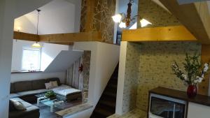 a living room with a couch and a fireplace at Overlinger Gästehaus in Westoverledingen