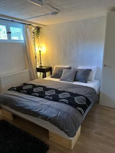 a bedroom with a large bed in a room at Charming apartment with industrial design close to city center in Växjö +21 photos